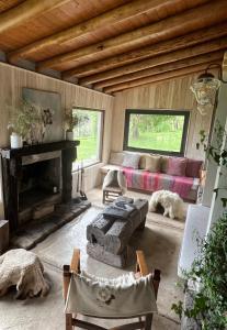 a living room with a couch and a fireplace at Estancia Palma in Tupungato