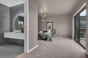 a bedroom with a bed and a mirror at Feriested ved Strand & svaberg in Kristiansand