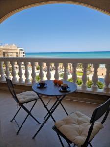 a table and two chairs on a balcony at Apartament La Mata in La Mata