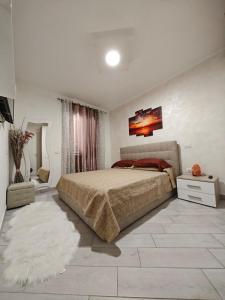 a bedroom with a large bed and a rug at Relais Vittoria in Castel San Lorenzo