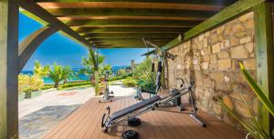 a gym with a bench and a stone wall at Talizeti Home in Sarti