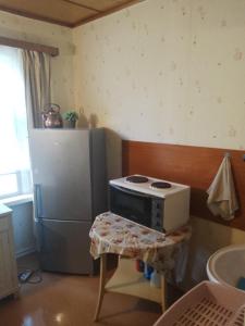 a kitchen with a stove and a refrigerator at Hiirevända Holiday House in Võsu