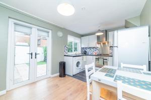 a kitchen with a table and a stove top oven at Excellent, comfortable location to visit Belfast in Holywood