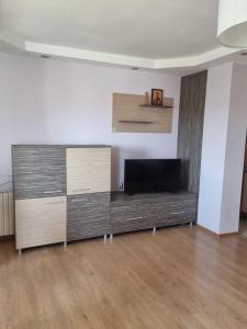 a living room with a large entertainment center with a flat screen tv at Apartment Rozen in Varna City