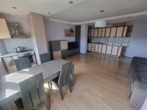 a kitchen and dining room with a table and chairs at Apartment Rozen in Varna City +11 photos