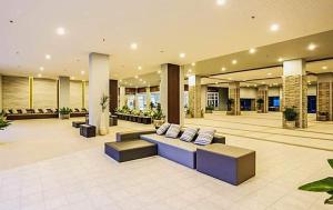 a lobby with couches and chairs in a building at Studio Seaview Jomtien floor12 23sqm in Jomtien Beach