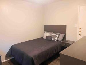 a bedroom with a large bed and a night stand at National Avenue Hotel in Milwaukee
