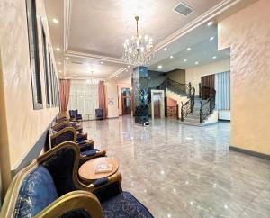 a lobby with a row of chairs and a chandelier at GM City Hotel in Baku +28 photos