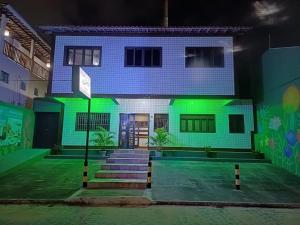 a house with green lights on the front of it at Pousada Ventos do Mar in Natal