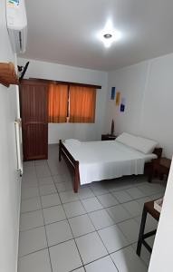 a bedroom with a large white bed in a room at Pousada Ventos do Mar in Natal