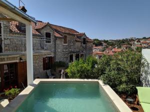 a swimming pool in the backyard of a house at Villa Moro House in Milna