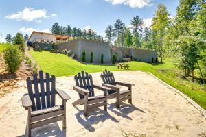 two chairs sitting in the sand in front of a house at Hot Tub and Game Room! Family Connelly Springs Home in Connelly Springs