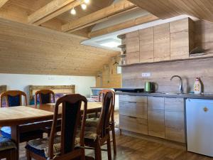 a kitchen with a wooden table and a dining room at Vinný apartmán Pouzdřany in Pouzdřany