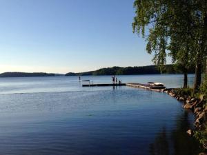 a group of people standing on a dock on a lake at Kullen in Börsebo
