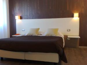 Postel nebo postele na pokoji v ubytování Hotel Toscana