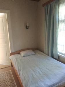 a small bed in a bedroom with a window at Hiirevända Holiday House in Võsu