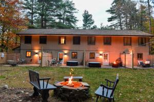 a fire pit in front of a house at Cozy Cottage in Middle Grove