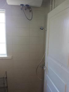 a shower with a shower head in a bathroom at Hiirevända Holiday House in Võsu +14 photos