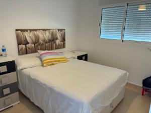 a bedroom with a bed with a pillow on it at Casita Azul in Moncófar