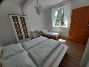 a bedroom with a large bed and a window at Chata u Vajdov in Stará Lehota