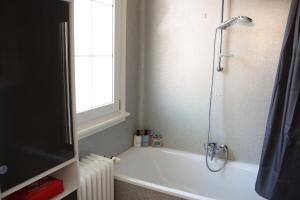 a bathroom with a tub and a shower with a window at Schwarzwald-Idylle in Triberg in Triberg