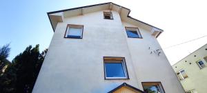a white building with windows on the side of it at Adam room piwnica in Wrocław