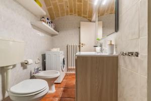 a small bathroom with a toilet and a sink at Holiday Home Dimora Effe in Castellaneta +34 photos
