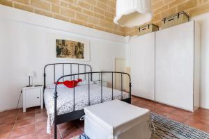 a bedroom with a bed and a stool in a room at Holiday Home Dimora Effe in Castellaneta