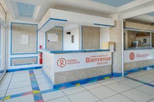a kitchen with a counter with a sign on it at Résidence Pierre & Vacances l'Ange Gardien in Villefranche-sur-Mer +37 photos