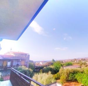 a balcony with a view of a building and a train at CasaTreFontane in Bovalino Marina