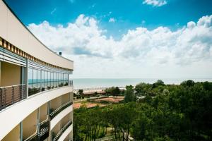 a view of the beach from the balcony of a building at Laguna Park Hotel 4Superior in Bibione
