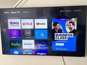 a television screen with a bunch of logos on it at Hot Tub Time Capsule with Waterbed & Jukebox in Middle Grove