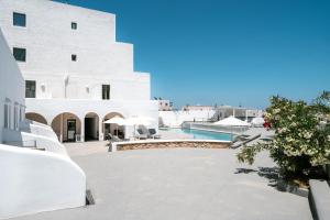a view of a building and a swimming pool at OMIROS HOTEL in Mesaria
