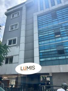 a large building with a sign in front of it at Lumis studio apartment in Hyderabad