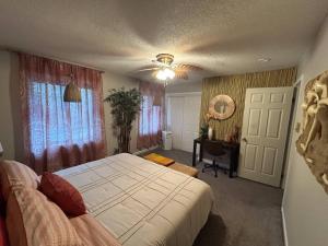 a bedroom with a bed and a ceiling fan at Spa Retreat - Hot Tub & Massage Chair in Middle Grove