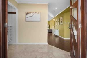 a hallway of a home with yellow walls and a door at Ocean Breeze at Rainbow Beach in Rainbow Beach +45 photos
