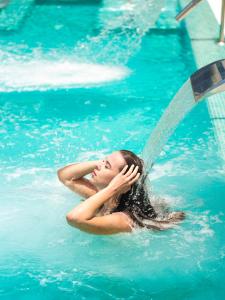 a woman is in the water in a swimming pool at MYND Yaiza in Playa Blanca +37 photos
