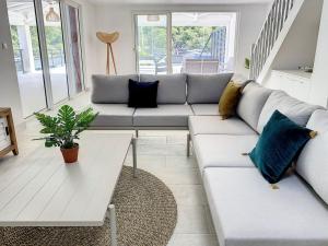 a living room with a couch and a table at Marina Beach 2 adjacent apartments marina view in Anse Marcel 