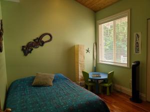 a bedroom with a bed and a table and a window at Expansive Dual-Kitchen Retreat in Point Roberts