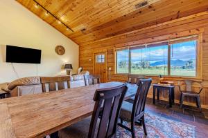 a dining room with a large wooden table and chairs at Yellowstone Crest Lodge in Livingston