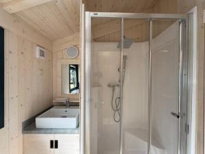 a bathroom with a shower and a sink at Camping Le Périgord in Saint-Astier +47 photos