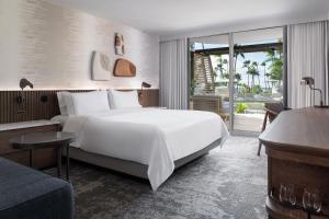 a bedroom with a large white bed and a living room at The Westin Maui Resort & Spa, Ka'anapali in Lahaina