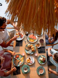 a group of people sitting around a table with food at MYND Yaiza in Playa Blanca