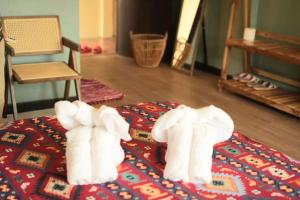 two towel elephants sitting on top of a table at Elegant Lanna Guesthouse in Chiang Mai +122 photos