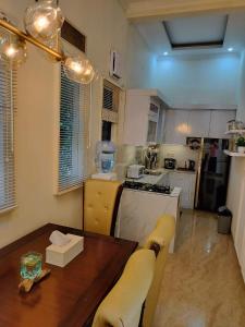 a kitchen with a wooden table and a dining room at Villa wanacosta in Taringgultonggok