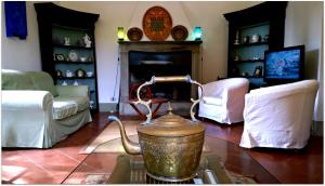 a living room with a tea kettle on a table at La Scheggia Holiday in Anghiari