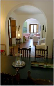 a living room with an archway and a table at La Scheggia Holiday in Anghiari