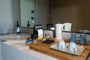 a kitchen with a counter top with a coffee maker at Il Fogliano Hotel New Life in Latina