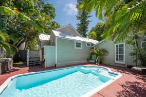 a swimming pool in front of a house at The Caroline Suite in Key West