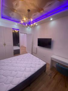a bedroom with a large white bed and a tv at Superbe appart au cœur d'Anvers in Antwerp +28 photos
